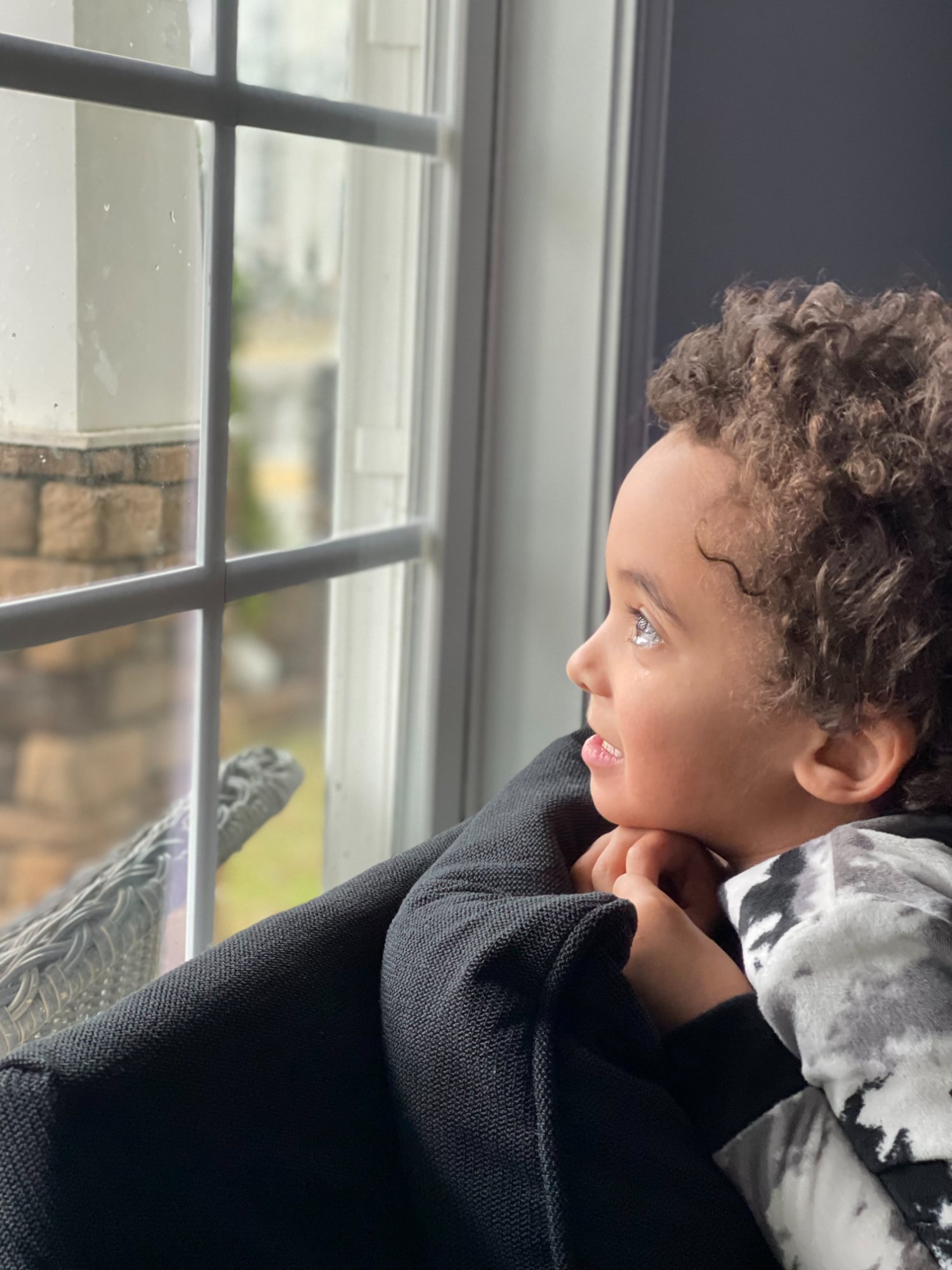 A child looking out the window — searching for hope